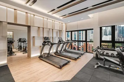 a gym with a row of treadmills and exercise machines at Prestige 2BR Agile BB WiFi Netflix in Kuala Lumpur