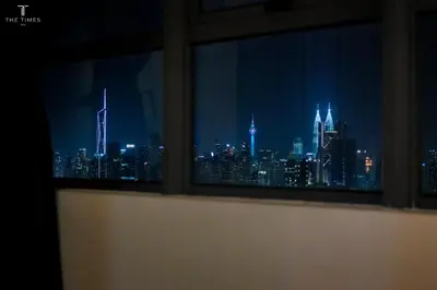 a view of a city skyline from a window at Arte Plus Luxury Suites with KLCC View in Kuala Lumpur