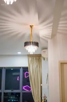a chandelier hanging from a ceiling in a room at Arte Plus Luxury Suites with KLCC View in Kuala Lumpur