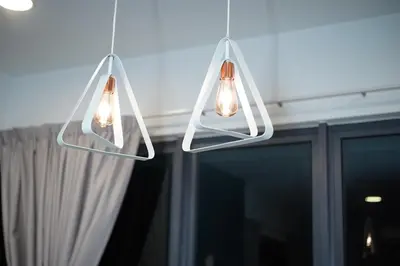 two lights hanging from a ceiling with a window at Arte Plus Luxury Suites with KLCC View in Kuala Lumpur