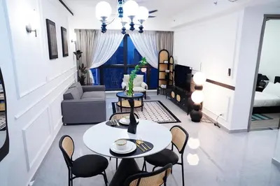 a living room with a table and chairs at Agile Residence Bukit Bintang by Luma in Kuala Lumpur