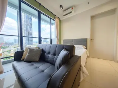 a living room with a couch and a large window at TRION The 108 Family Suite Pool & City view in Kuala Lumpur