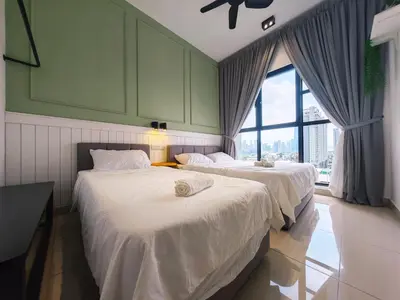 two beds in a room with a window at TRION POOL & KL City View The 110 Family Suite in Kuala Lumpur