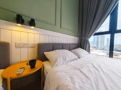 a bedroom with a bed with a table and a window at TRION POOL & KL City View The 110 Family Suite in Kuala Lumpur