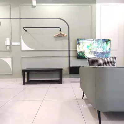 a living room with a tv and a table at TRION The 101 Family Suite Pool & KL City View in Kuala Lumpur