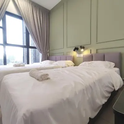 a bedroom with two beds with white sheets and a window at TRION The 101 Family Suite Pool & KL City View in Kuala Lumpur