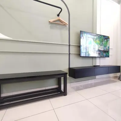 a living room with a tv and a lamp at TRION The 101 Family Suite Pool & KL City View in Kuala Lumpur