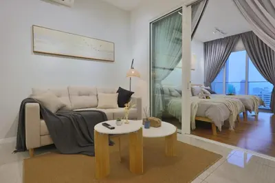 a living room with a couch and two beds at Quill Comport Suits KLCC in Kuala Lumpur