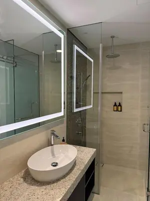 a bathroom with a sink and a shower with a mirror at Star Residance KLCC by Nexus 84 in Kuala Lumpur