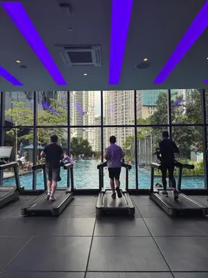 a group of people on a treadmill looking at the water at Star Residance KLCC by Nexus 84 in Kuala Lumpur