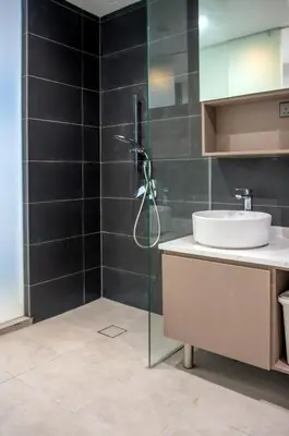 a bathroom with a sink and a shower at NOVO Ampang Stylish Studio & 1BR with Infinity Pool near KLCC & Gleneagles in Kuala Lumpur