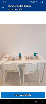 a white table with two plates on top of it at summer suites studios in Kuala Lumpur