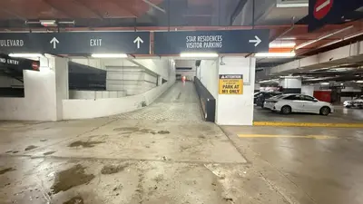 an empty parking garage with cars parked in it at Star Residences KLCC by Nexus 62 in Kuala Lumpur