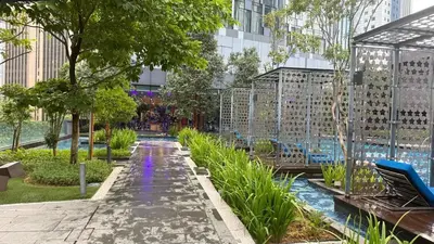 a garden with a pool in a building at Star Residences KLCC by Nexus 62 in Kuala Lumpur