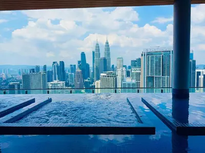 a rooftop swimming pool with a view of the city at THE COLONY BY INFINITUM by ZENTRIP in Kuala Lumpur