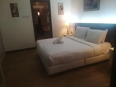 a bedroom with a large white bed in a room at Happy holiday suites at times square KL in Kuala Lumpur