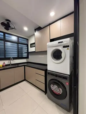 a kitchen with a washing machine and a washer at Alaxis Suite Home By Residensi Brickfields in Kuala Lumpur