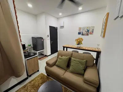 a living room with a couch and a television at Neu Suites #2BR Apartment by LammyNora in Kuala Lumpur