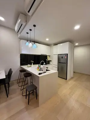 a kitchen with a white counter and a table and chairs at KL Star Residences By Nexus Nest 25 in Kuala Lumpur