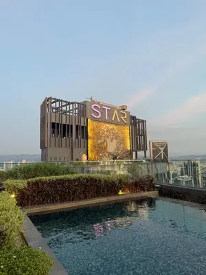 a building with a swimming pool in front of it at KL Star Residences By Nexus Nest 25 in Kuala Lumpur