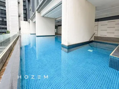 a swimming pool with blue tiles in a building at 2BR3B Hozem KL1602 Apartment KLCC in Kuala Lumpur