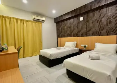 a hotel room with two beds and a desk at Swing & Pillows - Imbi Bukit Bintang in Kuala Lumpur