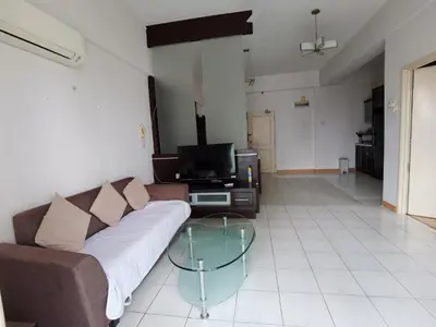 a living room with a couch and a glass table at Seri Bukit Ceylon Bukit Bintang in Kuala Lumpur