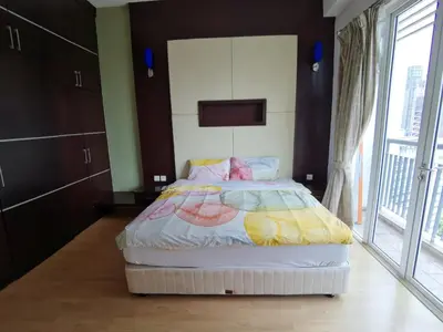 a bedroom with a bed and a large window at Seri Bukit Ceylon Bukit Bintang in Kuala Lumpur