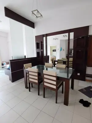 a dining room with a glass table and chairs at Seri Bukit Ceylon Bukit Bintang in Kuala Lumpur