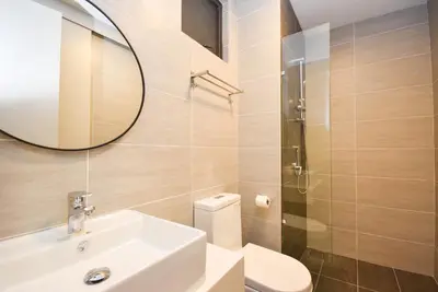 a bathroom with a sink and a mirror and a toilet at Trion KL by CityNest in Kuala Lumpur