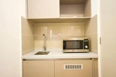 a kitchen with a microwave and a sink at Trion KL by CityNest in Kuala Lumpur