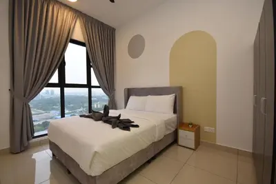 a bedroom with a bed and a large window at Trion KL by CityNest in Kuala Lumpur