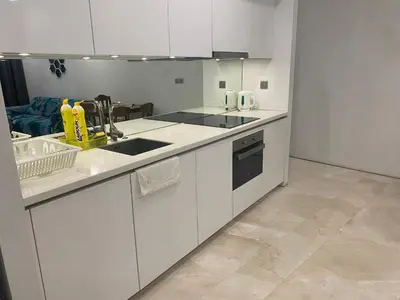 a white kitchen with a sink and a stove at Sky Suites KLCC By Stay Happy in Kuala Lumpur