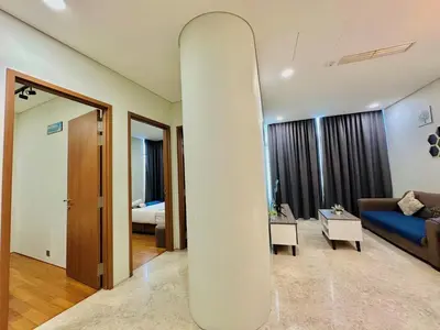 a living room with a surfboard in the middle of a room at Sky Suites KLCC By Stay Happy in Kuala Lumpur