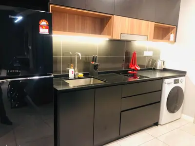 a kitchen with a sink and a washing machine at Axon popular Suite Kl Bukit -Bintang Klcc in Kuala Lumpur