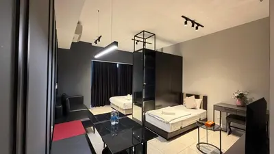 a living room with a couch and a table at Axon popular Suite Kl Bukit -Bintang Klcc in Kuala Lumpur