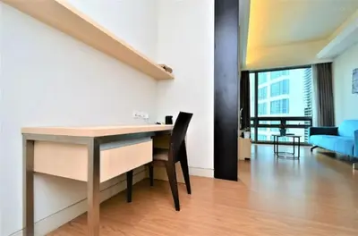 a dining room with a desk and a living room at Putra Suite KL in Kuala Lumpur