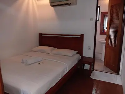 a bedroom with a bed and a bathroom with a toilet at HOTEL I VILLA INN Bukit Bintang KL in Kuala Lumpur
