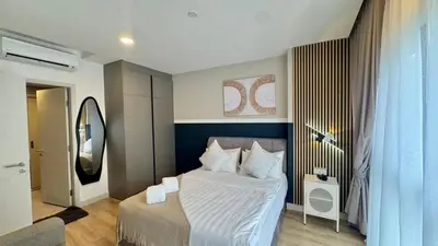 a bedroom with a bed and a mirror at Warm & Cozy 2Bedroom Apartment at The Atrium Ampang by OKBnB in Kuala Lumpur