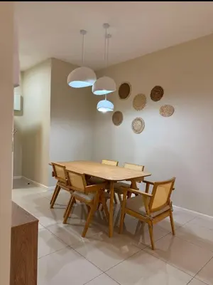 a dining room with a wooden table and chairs at Arte Mont Kiara by Skyline in Kuala Lumpur