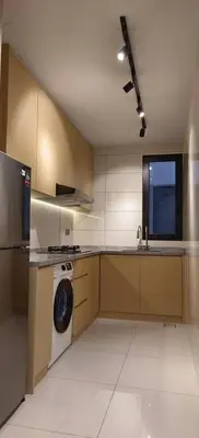 a kitchen with a washing machine and a sink at Arte Mont Kiara by Skyline in Kuala Lumpur