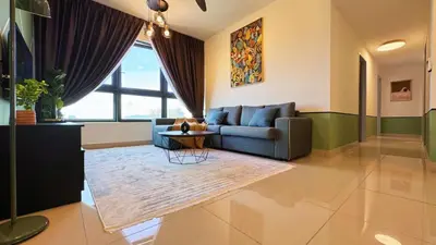a living room with a blue couch and a table at M Vertica KL City Fully Air-Con Home in Kuala Lumpur