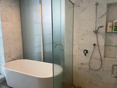 a bathroom with a tub and a glass shower at platinum suites klcc By Palmas in Kuala Lumpur