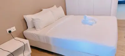 a white bed with a blue stuffed animal on it at platinum suites klcc By Palmas in Kuala Lumpur