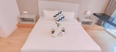 a white bed with two stuffed animals on top of it at platinum suites klcc By Palmas in Kuala Lumpur