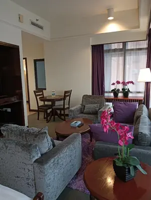 a living room with couches and a table at Crown Suits At Times Square in Kuala Lumpur