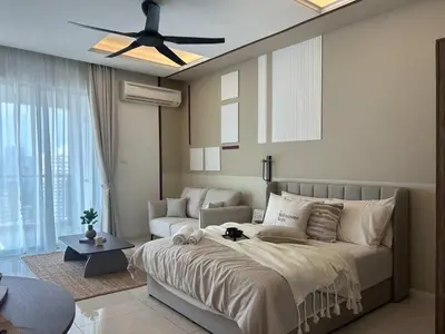 a bedroom with a bed and a couch and a ceiling fan at Elegant Studio - Upscale Neighbourhood of Hartamas in Kuala Lumpur