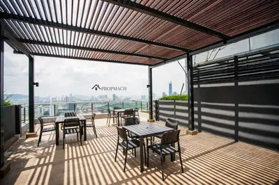 a patio with tables and chairs and a view of the city at Neu Suites By Propmach in Kuala Lumpur