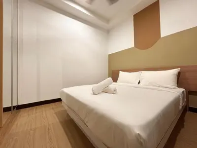 a bedroom with a large white bed with white pillows at Casa Residency Bukit Bintang by PILLOWTALKS in Kuala Lumpur