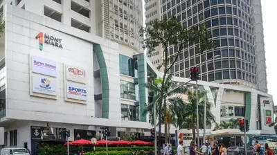a building in a city with people walking in the street at netflix&chill Arcoris Soho 2R1B Mont Kiara in Kuala Lumpur